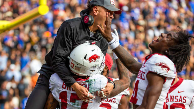 Razorbacks Tyrone Broden (17) teammates and staffers celebrate win in overtime over Florida
